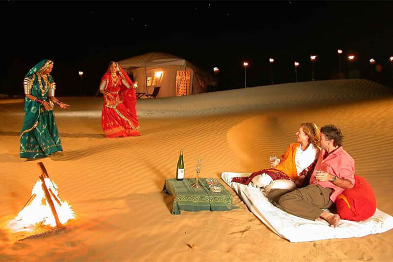 Langa musicians and folk dancers performing under the stars at the Jaisalmer Desert Festival.
