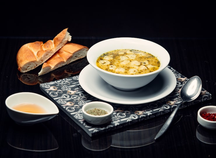 Light Indian dinner setup with a warm vegetable soup and roasted papad for easy digestion.