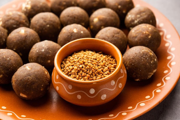 Homemade traditional Indian Methi Ladoo with jaggery and nuts for postpartum recovery.
