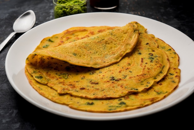 A crispy golden besan chilla gram flour pancake served with tomato ketchup A crispy golden besan chilla gram flour pancake served with tomato ketchup