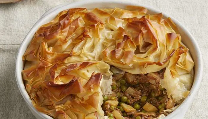 Golden, plant-based mushroom and lentil Wellington for a vegetarian dinner party."