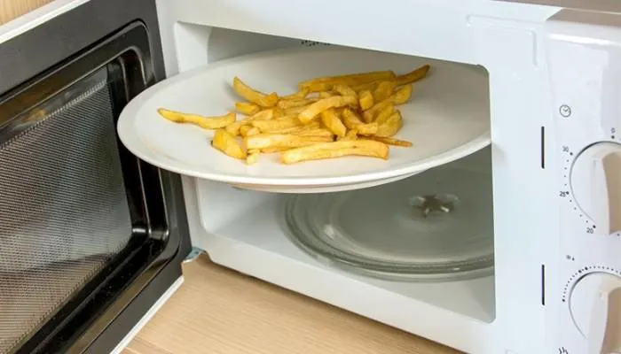 A close-up shot of soggy, unappealing French fries on a plate. A close-up shot of soggy, unappealing French fries on a plate.