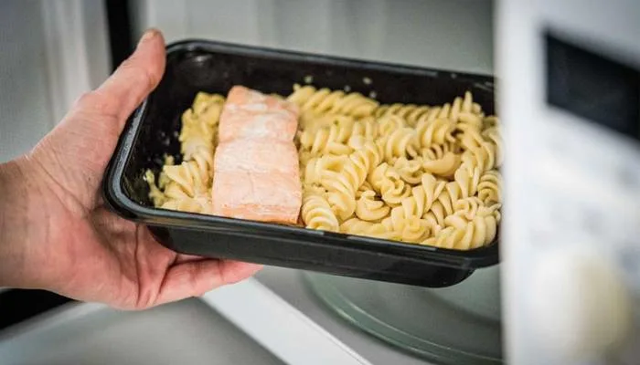 A refreshing, healthy salad topped with cold, cooked salmon, demonstrating a better way to eat leftover seafood. A refreshing, healthy salad topped with cold, cooked salmon, demonstrating a better way to eat leftover seafood.