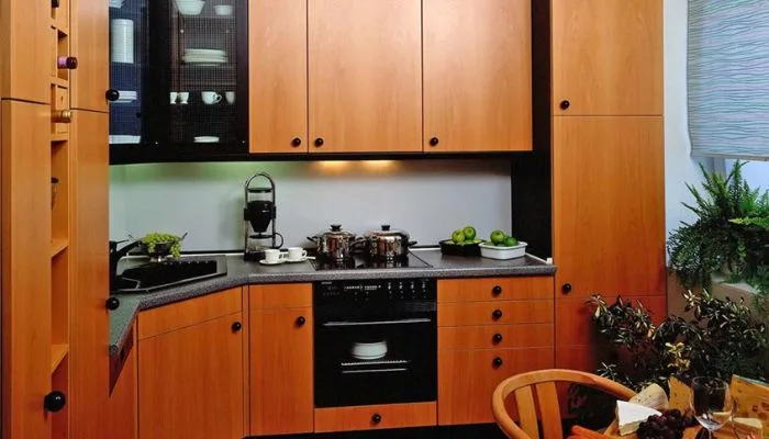 Minimalist yuppie-aesthetic 1980s kitchen featuring black ash wooden units and matching black handles. Minimalist yuppie-aesthetic 1980s kitchen featuring black ash wooden units and matching black handles.