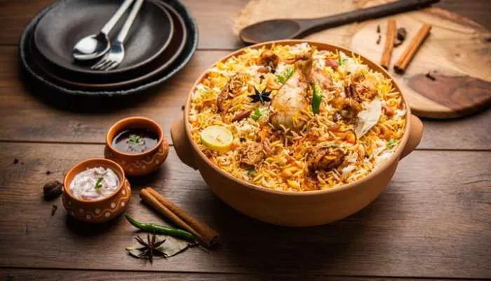 A steaming pot of aromatic chicken biryani spiced with star anise, cardamom, and saffron. A steaming pot of aromatic chicken biryani spiced with star anise, cardamom, and saffron.