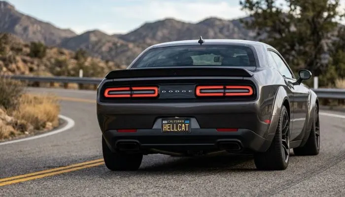 Rear view of a Dodge Challenger showing its wide haunches, full-width taillights, and muscular rear profile