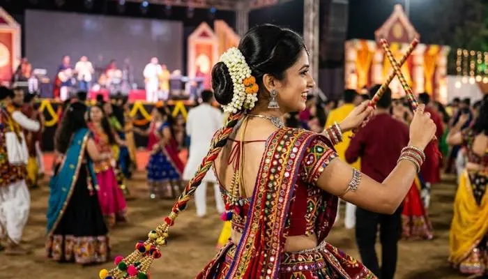 Woman with traditional low bun gajra and single braid hair extension parandi for Navratri Garba Woman with traditional low bun gajra and single braid hair extension parandi for Navratri Garba