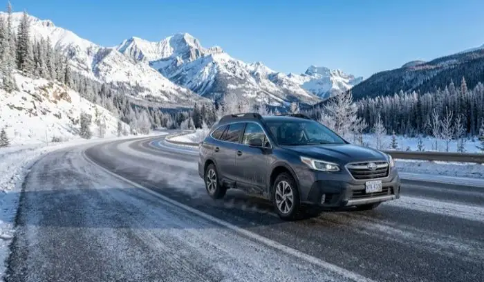 A vehicle driving on a dry, freezing asphalt road in clear sub-zero temperature weather A vehicle driving on a dry, freezing asphalt road in clear sub-zero temperature weather
